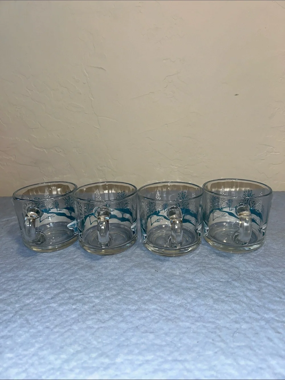 Set of 4Anchor Hocking clear glass coffee mugs featuring a blue-and-white winter